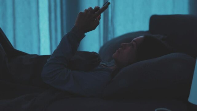 Addicted woman connecting with her phone at night
