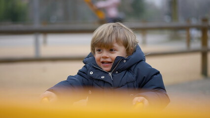 Baby toddler playing at seesaw playground
