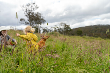 farming family together in a field regenerative organic farmer, taking soil samples and looking at plant growth in a farm. practicing sustainable agriculture in spring