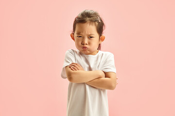 Offended Chinese Appearance Child Girl With a Sullen Face Defiantly Crossing Arms, Angry Looking to...