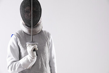 Fencer with epee on white background, space for text