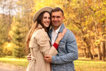 Happy couple spending time together in autumn park