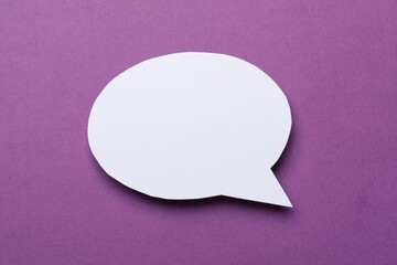 Blank speech bubble on purple background. Space for text