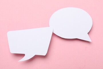 Blank speech bubbles on light pink background. Space for text