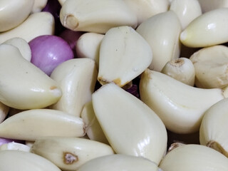 Close up photo of peeled shallots and garlic. Ingredients for cooking shallots and garlic.