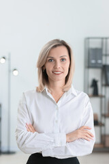 Portrait of businesswoman with crossed arms in office