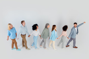 Naklejka premium Diverse group of professionals working together in harmony on a light grey background, top view