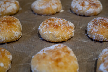 Culinary background with baked cookies. Cookies on baking paper close-up.