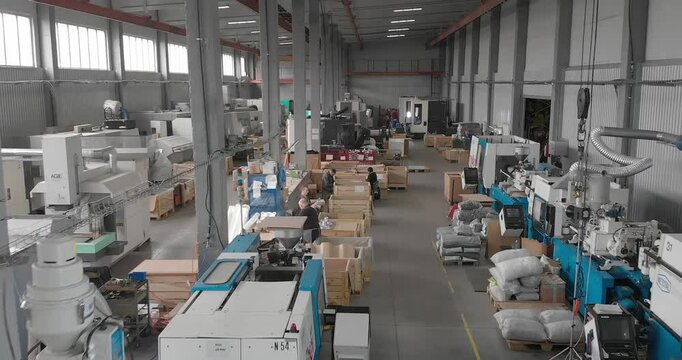 Inside a large workshop for the production of plastic parts. Interior of a factory producing injection molded plastic parts
