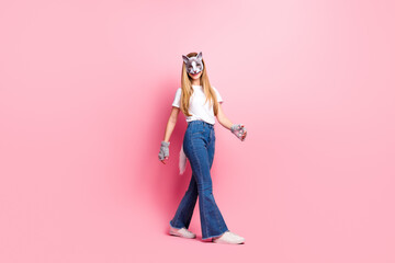 Young woman in animal disguise against pink background, embodying quadrobica culture with trendy teenage style