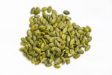 Dried pumpkin seeds isolated on white background. Top view.