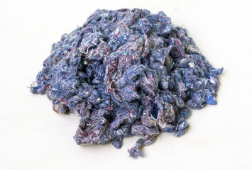 Recycled textile fibers, derived from old garment fabric cotton, are used to create pillows,...