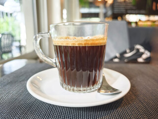 Black coffee art on a romantic table in a naturally lit coffee shop.