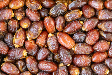 Dried date palm fruits as background. Dates are a popular fruit consumed during the Islamic holy month of Ramadan.