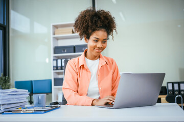 A cute African American businessman works diligently at his office desk, managing accounting tasks,...