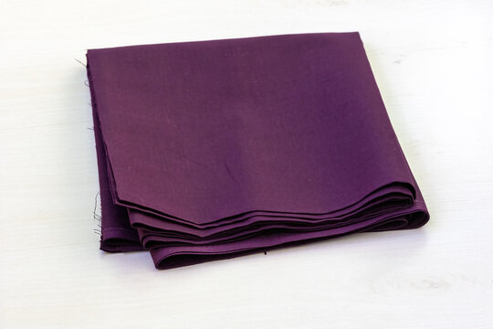 Dark violet unstitched cotton fabric, suitable for crafting women's blouses, petticoats, salwars, kameezes, and more, is showcased against a white backdrop.