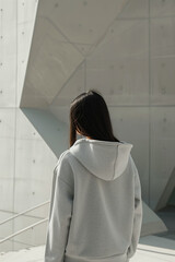 Stylish Gray Hoodie Mockup Featuring a Minimalist Urban Outfit for Modern Women in a Trendy Streetwear Setting