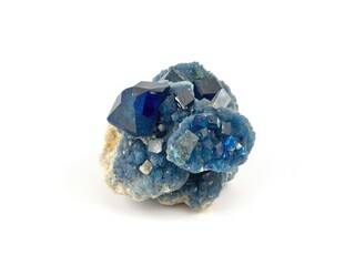 A close-up shot of mineral corundum in deep blue shade, set against a plain white background, smooth, geology, mineral