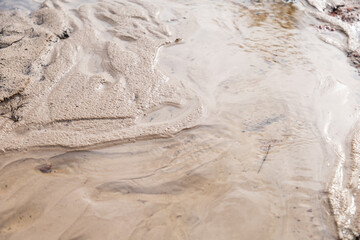 Texture of the sand. Sand and water