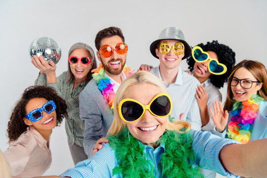 Multigenerational team celebrating together in a fun and playful atmosphere with props and sunglasses
