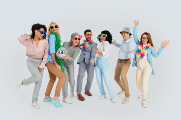 Fototapeta premium Group of diverse coworkers celebrating together in colorful costumes, showcasing team spirit and unity in a cheerful office environment