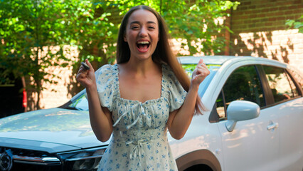 Excited pleased happy Caucasian woman female smiling girl buyer driver winner holding car keys...