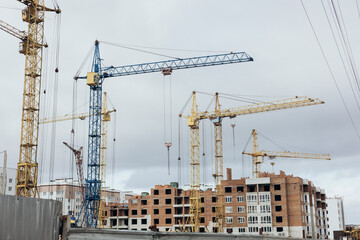 Construction site with tower cranes. Construction of multi-storey buildings.