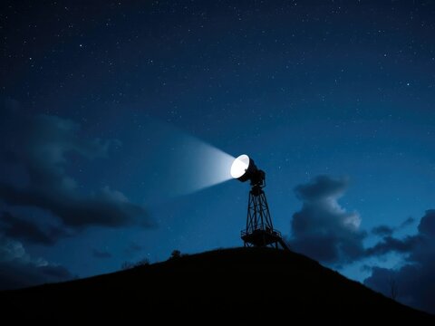 A massive searchlight perched atop a hill shines its light upwards into the starry night sky filled with clouds and constellations, celestial, hill