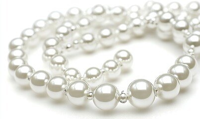 Fototapeta premium Pearl necklace strands on white background, ideal for jewelry or fashion themes