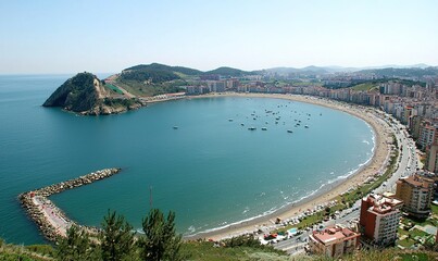 Aerial bay view, coastal city, boats, beach, clear sky, summer tourism