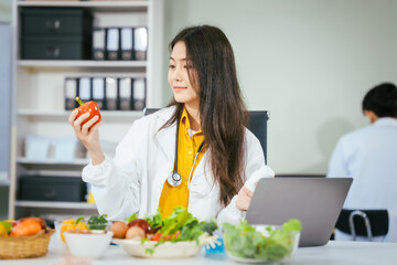 Two nutritionists,female and male, work in a hospital, analyzing vegetable and fruit salads,...