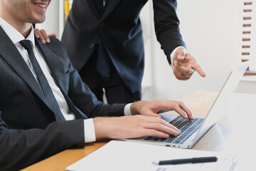 financial advisory services. Asian advisor showing plan of investment to clients in the consultancy office.
