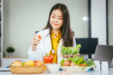 Two nutritionists,female and male, work in a hospital, analyzing vegetable and fruit salads,...