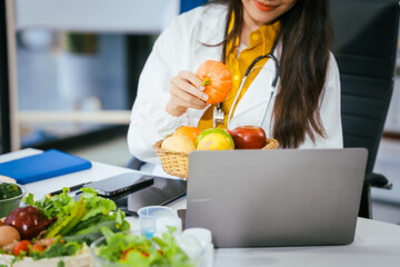 Two nutritionists,female and male, work in a hospital, analyzing vegetable and fruit salads,...
