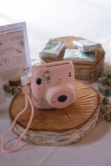 Retro camera on a wooden stand with a gift box in the background