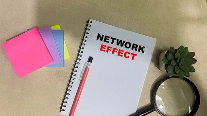 Concept of Network Effect write on book isolated on Wooden Table.