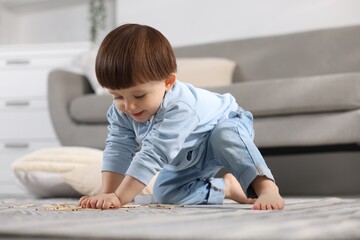 Little boy playing with matches at home. Child in danger
