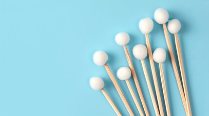 Closeup of Wooden Cotton Buds on Light Blue Background