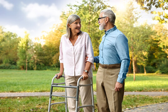 Senior couple with walking frame in park