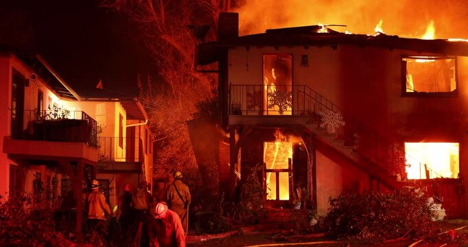 Altadena, California, USA - January 8, 2025: Firefighters work to put out a blaze at an apartment complex caused by the Eaton Fire.