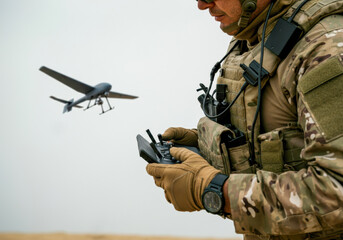 Soldier operates drone in military training exercise in desert environment during daylight hours