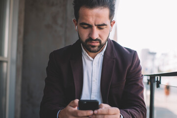 Confident boss using phone at balcony