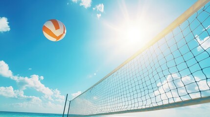 Volleyball soaring over net, bright sunny day, beach scene.