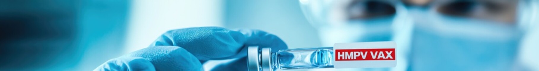 A researcher holds a vial labeled HMPV VAX in a lab setting in China in 2025, focusing on developing vaccines against metapneumovirus