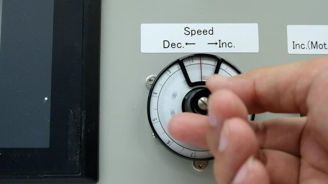Operator hand grap and turn knob of scale dial meter rotation increase gain from zero to ten unit
