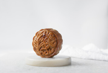 Fototapeta premium homemade mooncakes on a white background, top view of baked mooncakes on white table, process of making mooncakes for Lunar New Year and mid autumn festival