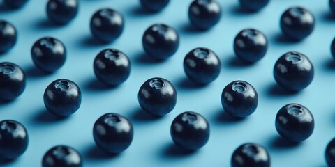 Fototapeta premium Blueberries on Blue Surface