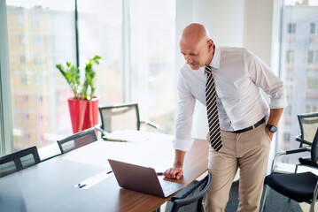 Businessman using laptop in a modern office