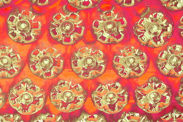 Red abstract wall made from the bottoms of plastic bottles