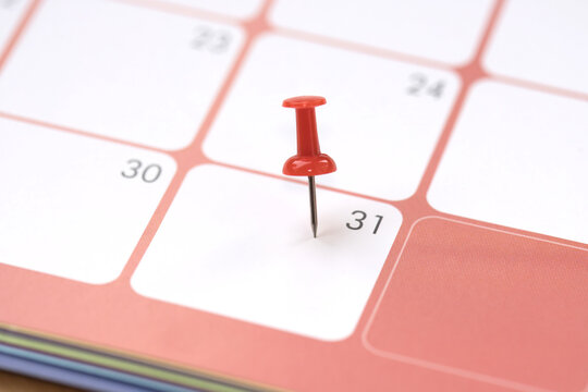 Calendar entry: Number 31 pinned with a red push pin or thumbtack, symbolizing the “Save the Date” concept.